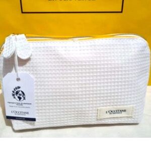 NWT L'Occitane en Provence Cosmetic bag with several samples/trial sizes.